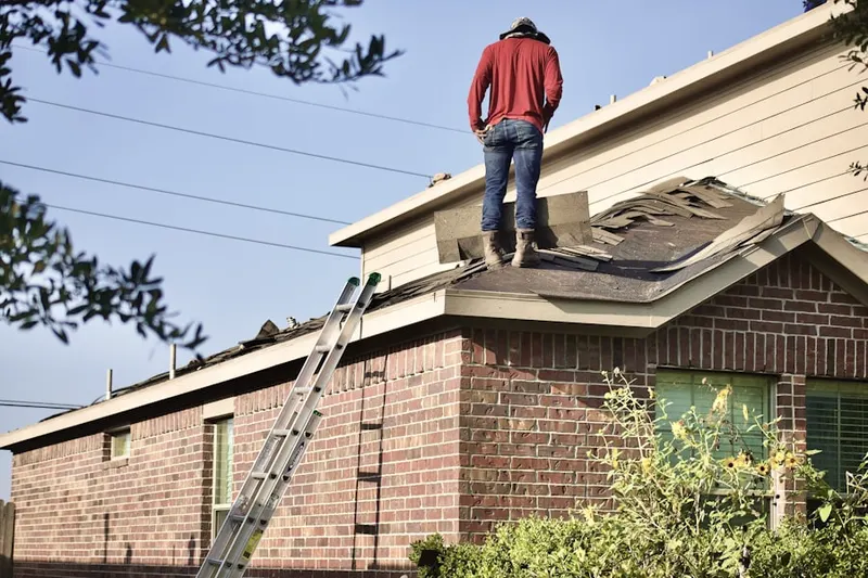 Professional roofer working on a residential roof in Sylmar